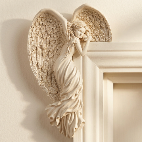 Angel ornament perched on the top edge of a doorframe